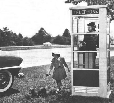 The ubiquitousness of the telephone booth in modern culture is exemplified by this exaggerated scenario: a booth on the side of the road, from an AT&amp;T ad circa 1954.  (Courtesy phonebooth.org)