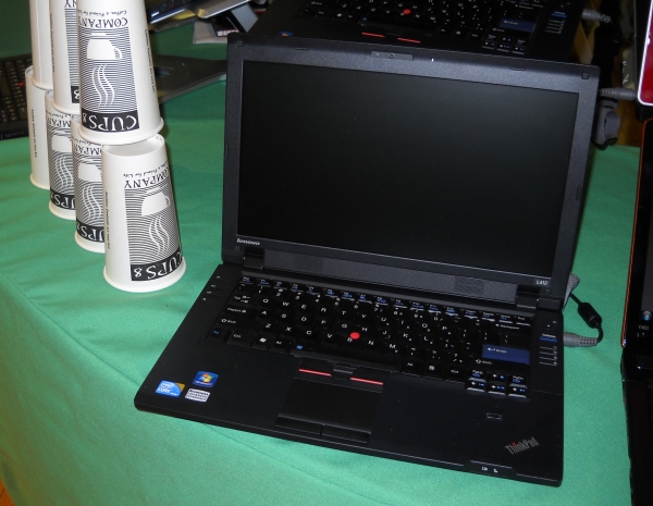 The Lenovo L412 is pictured here alongside...yes, that's right, a stack of recyclable cups.