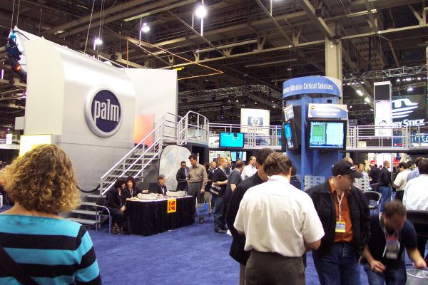 The bustling activity of the Palm booth at the COMNET conference in Washington, DC, November 15, 2000.